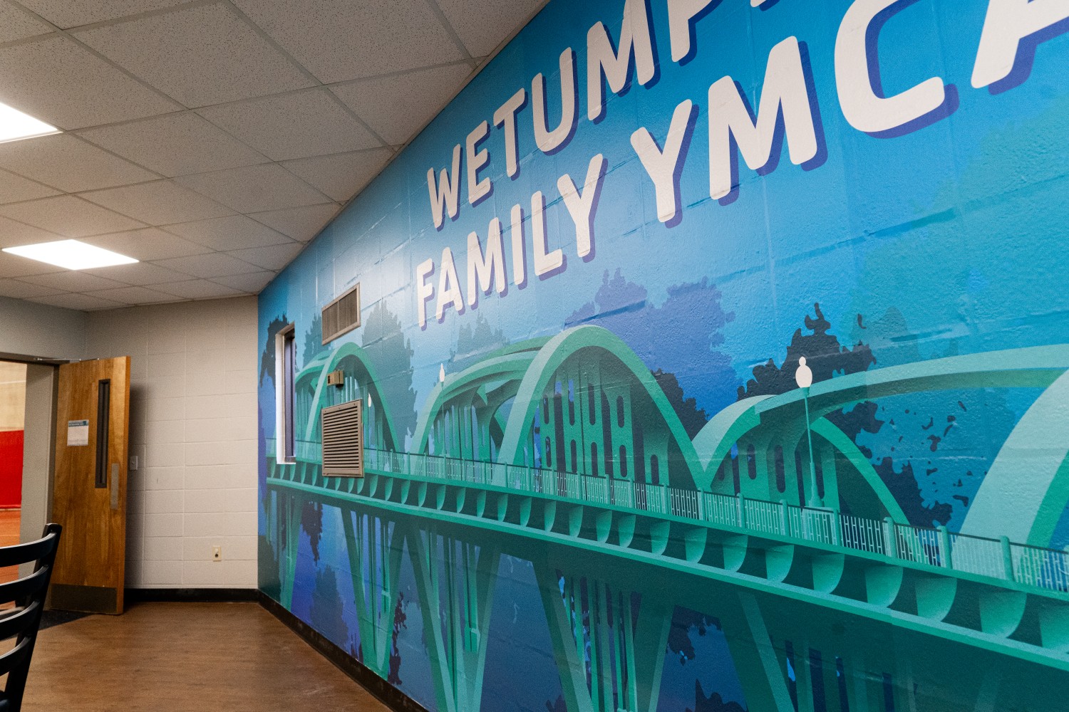 Image of a blue wall wrap of the Bibb Graves bridge in Wetumpka AL