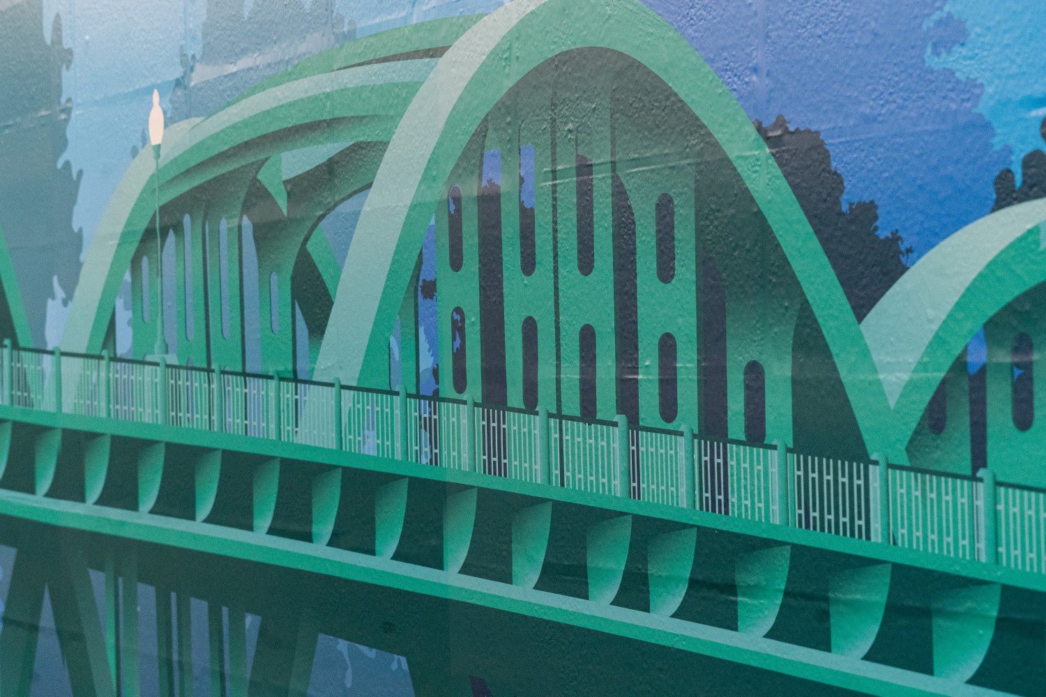 Image of a blue wall wrap of the Bibb Graves bridge in Wetumpka AL