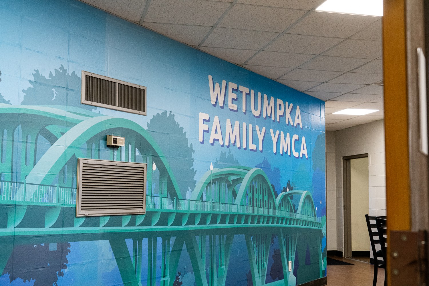 Image of a blue wall wrap of the Bibb Graves bridge in Wetumpka AL