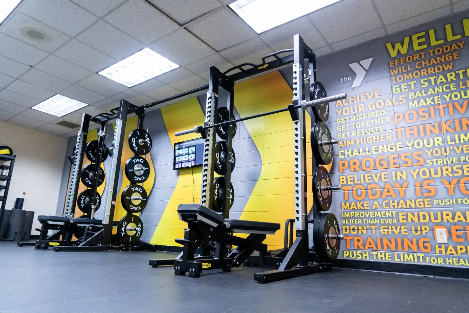 A modern gym with a gray & yellow full cover wall wrap
