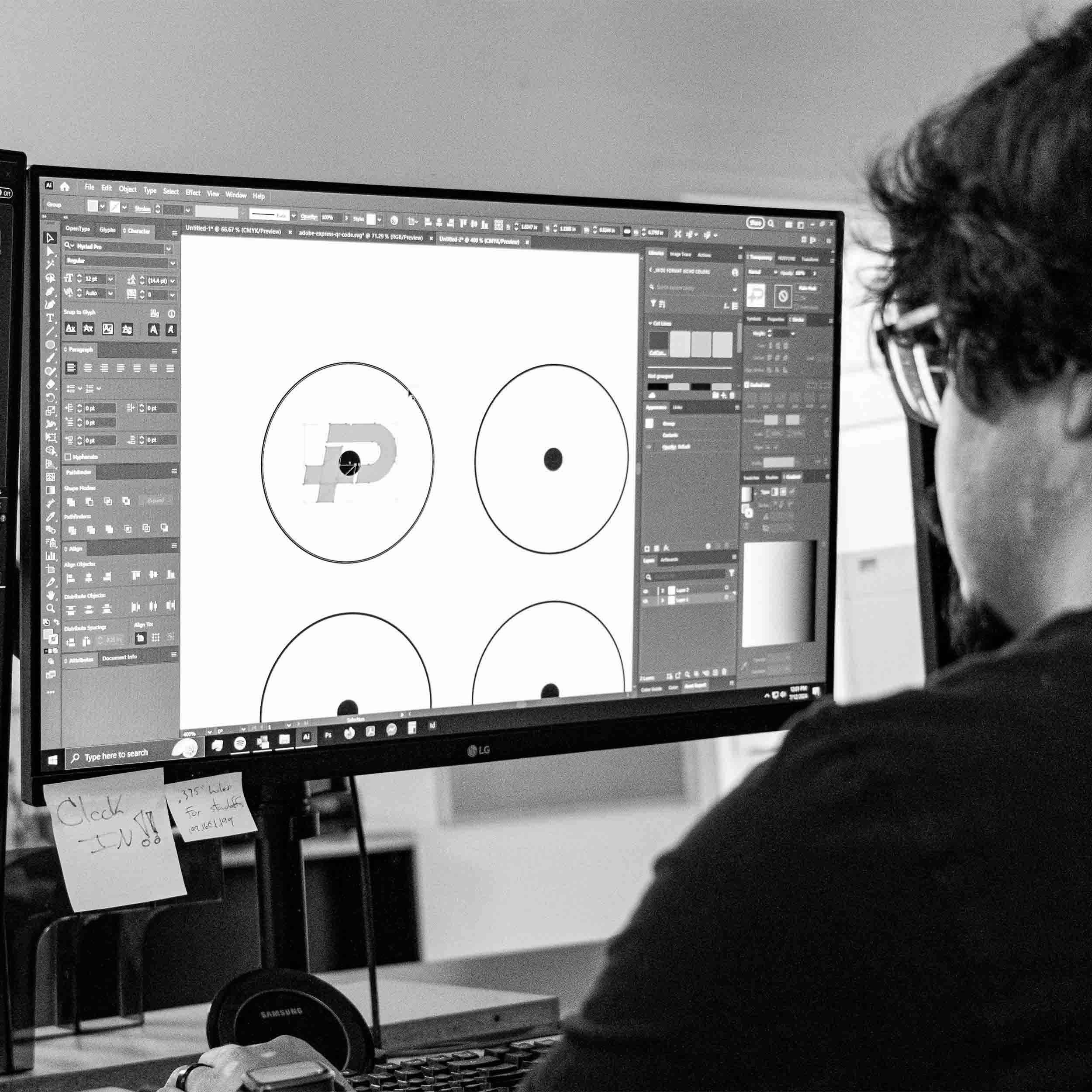 A man sitting at a desk doing design work