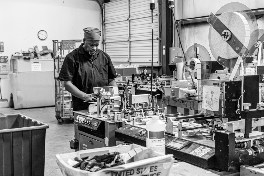 Man working on mailing machine