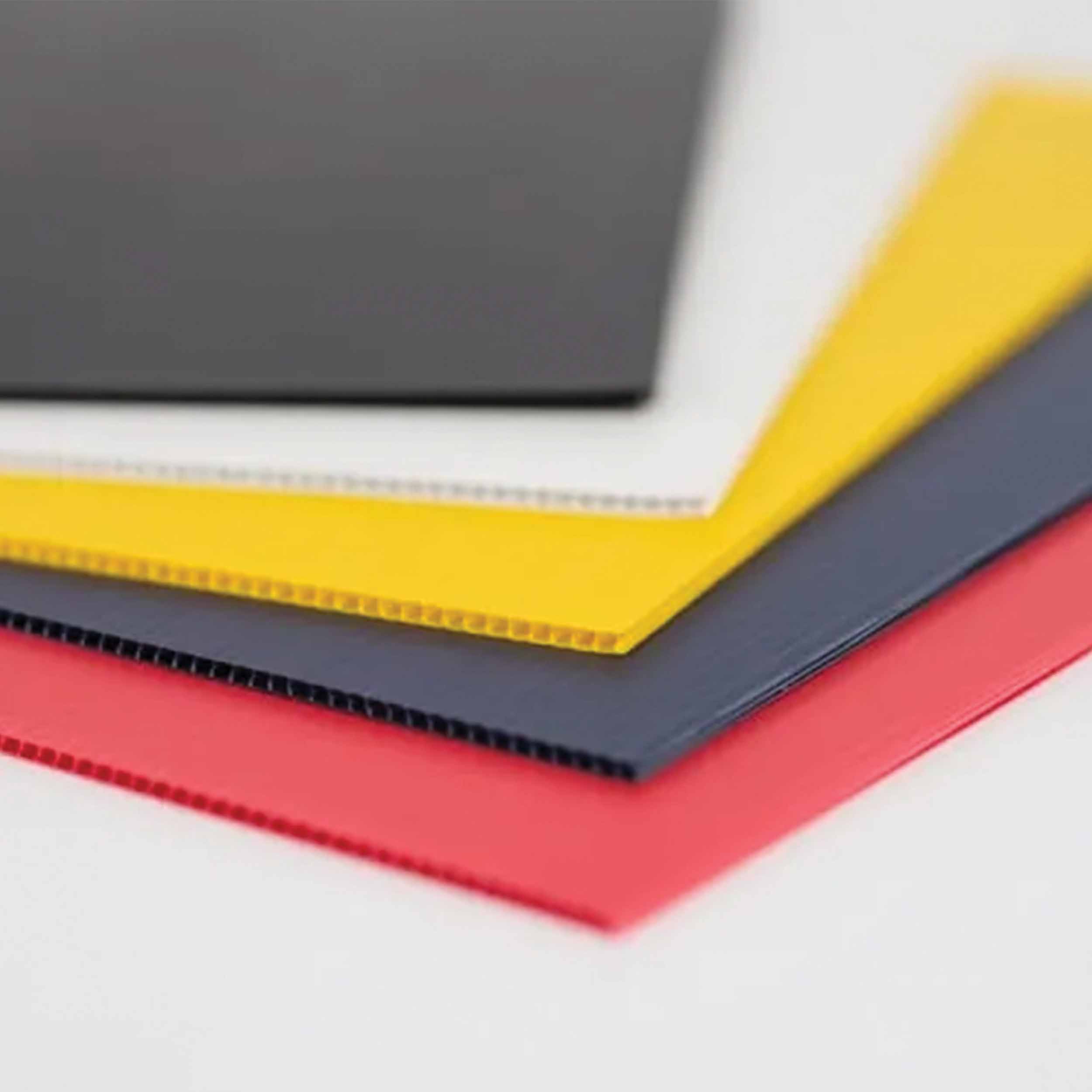 Black, white, yellow, gray, and red square coroplast samples laid out.