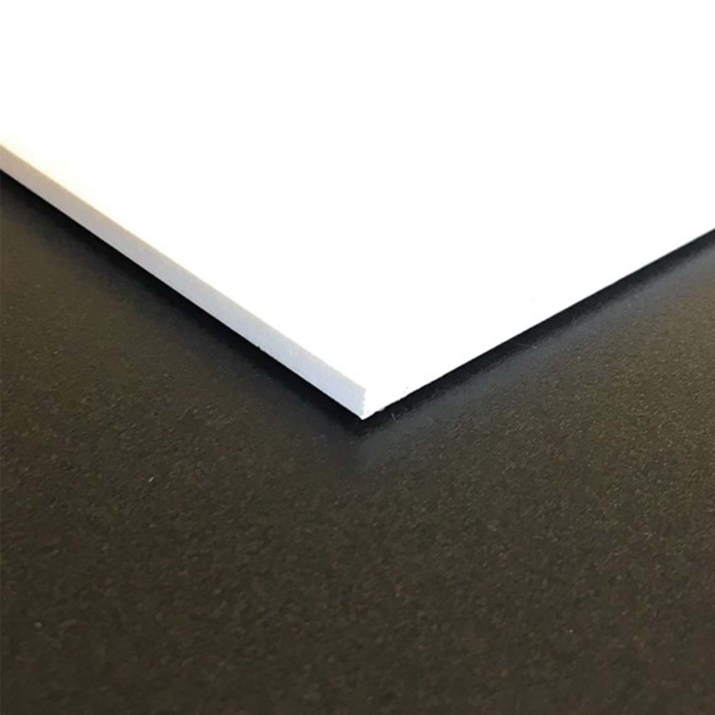 White square edge of PVC sheet laying on black background.